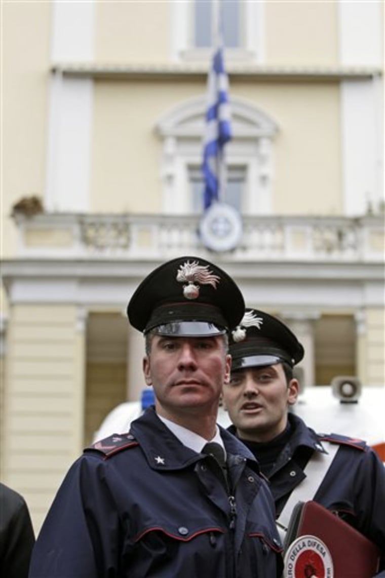 Carabinieri officers stand outside the Greek Embassy in Rome on Monday where a package bomb was found, then later defused. Anarchists are suspected of planting the explosive.